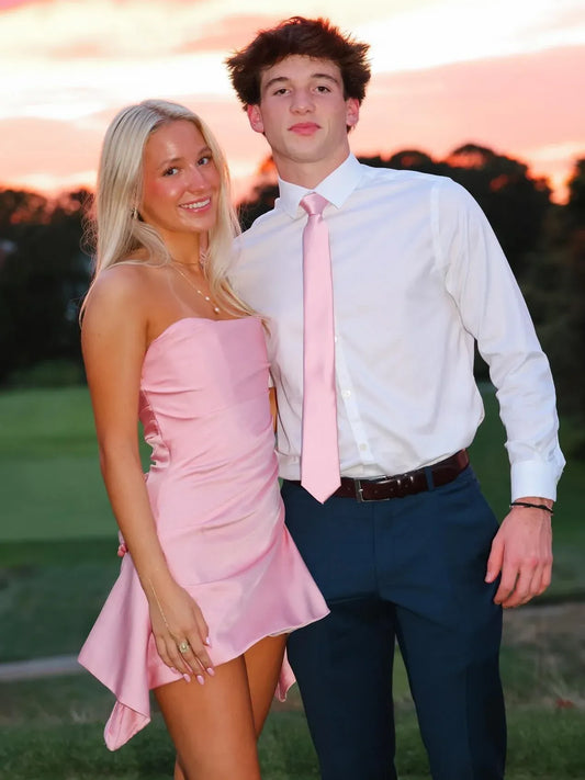 Loverlm baby pink strapless mini homecoming dress with a fitted ruched bodice and asymmetric draped hem, styled for a homecoming couple photo
