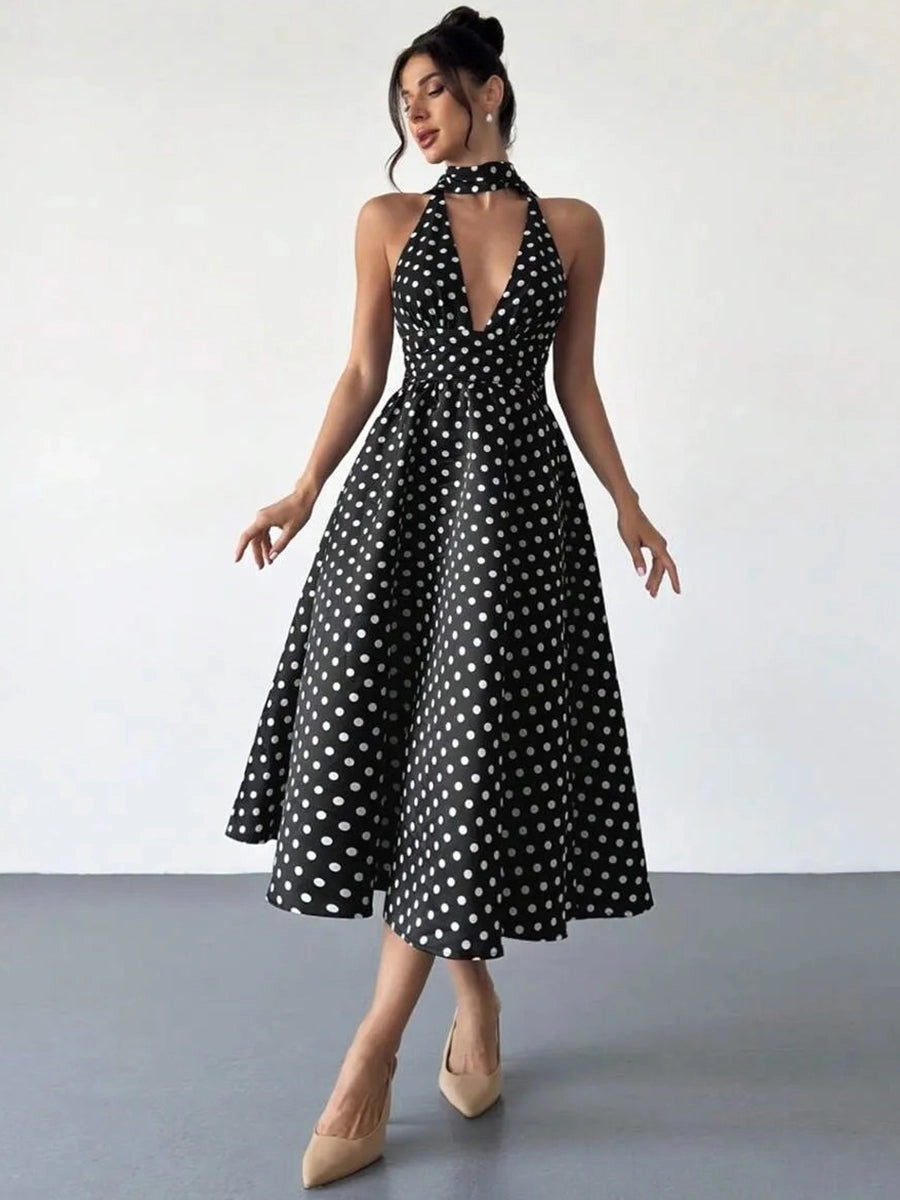 Black satin polka dot halter midi wedding guest dress with plunging neckline front view
