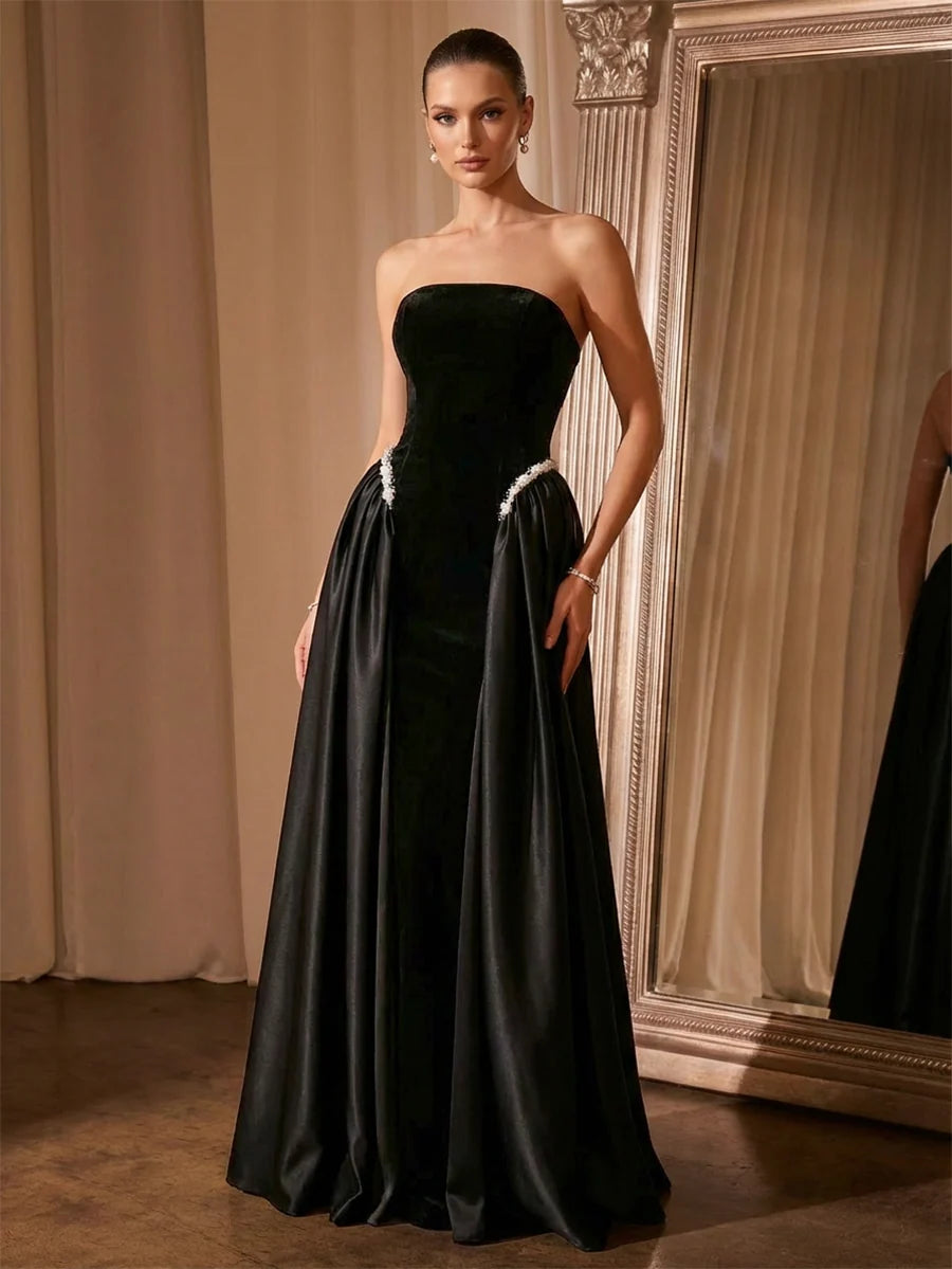 Black strapless evening dress with velvet-look bodice, satin A-line skirt, and pearl-like waist accents by Loverlm