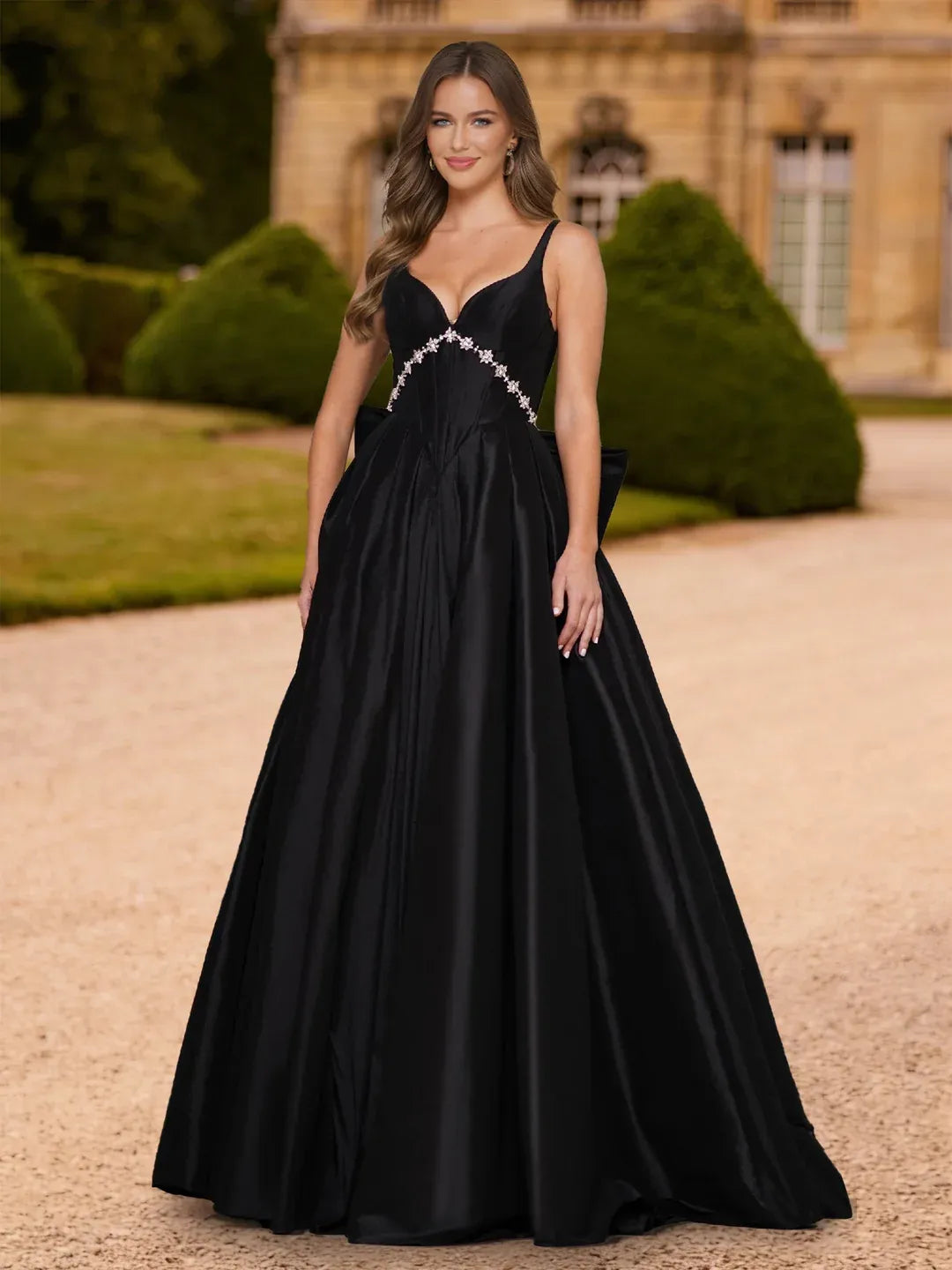 Front view of Loverlm black A-line prom dress with sweetheart neckline, silver floral waist embellishments and floor-length skirt