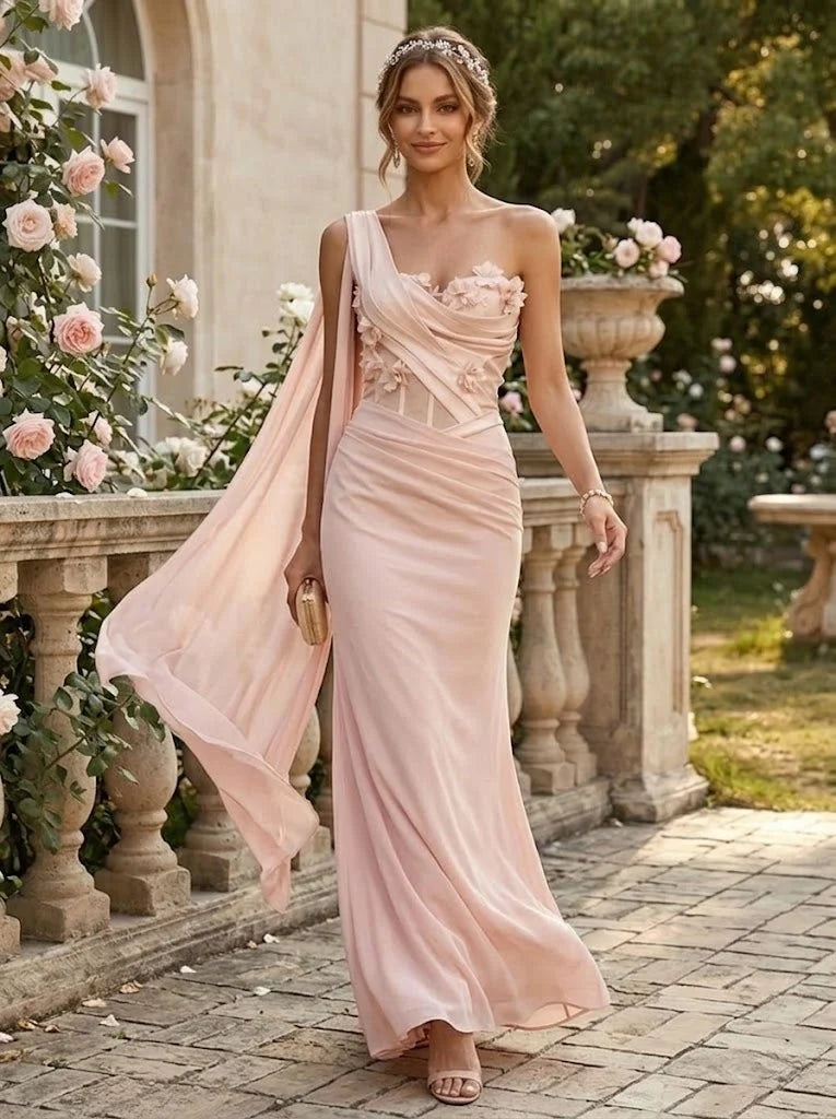 Blush pink one-shoulder chiffon evening dress with 3D floral appliques, draped corset bodice, flowing shoulder cape and floor-length skirt by Loverlm