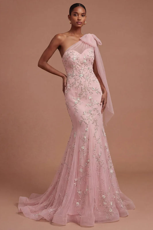 Loverlm blush pink mermaid prom dress with one shoulder tulle bow, sweetheart bodice, silver floral embroidery and floor length skirt front view