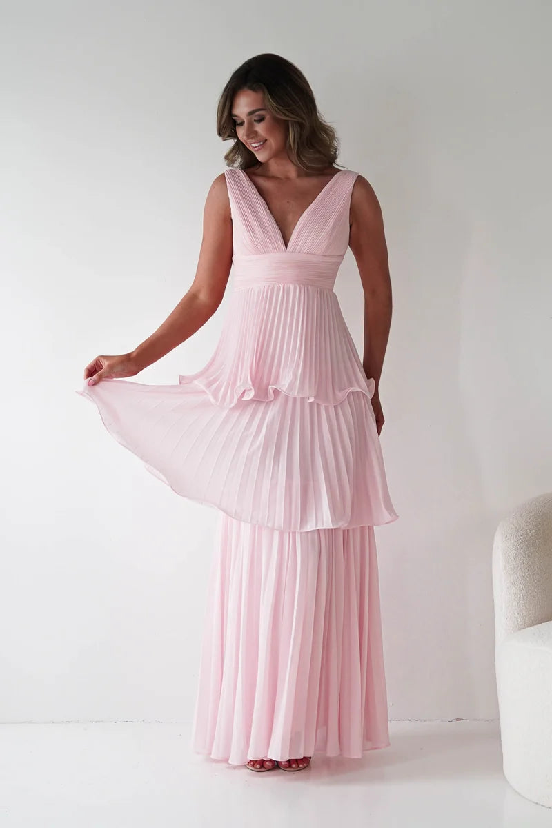 Loverlm blush pink pleated maxi wedding guest dress featuring a deep V-neckline, wide straps, high waist and three-tier flowing skirt front view