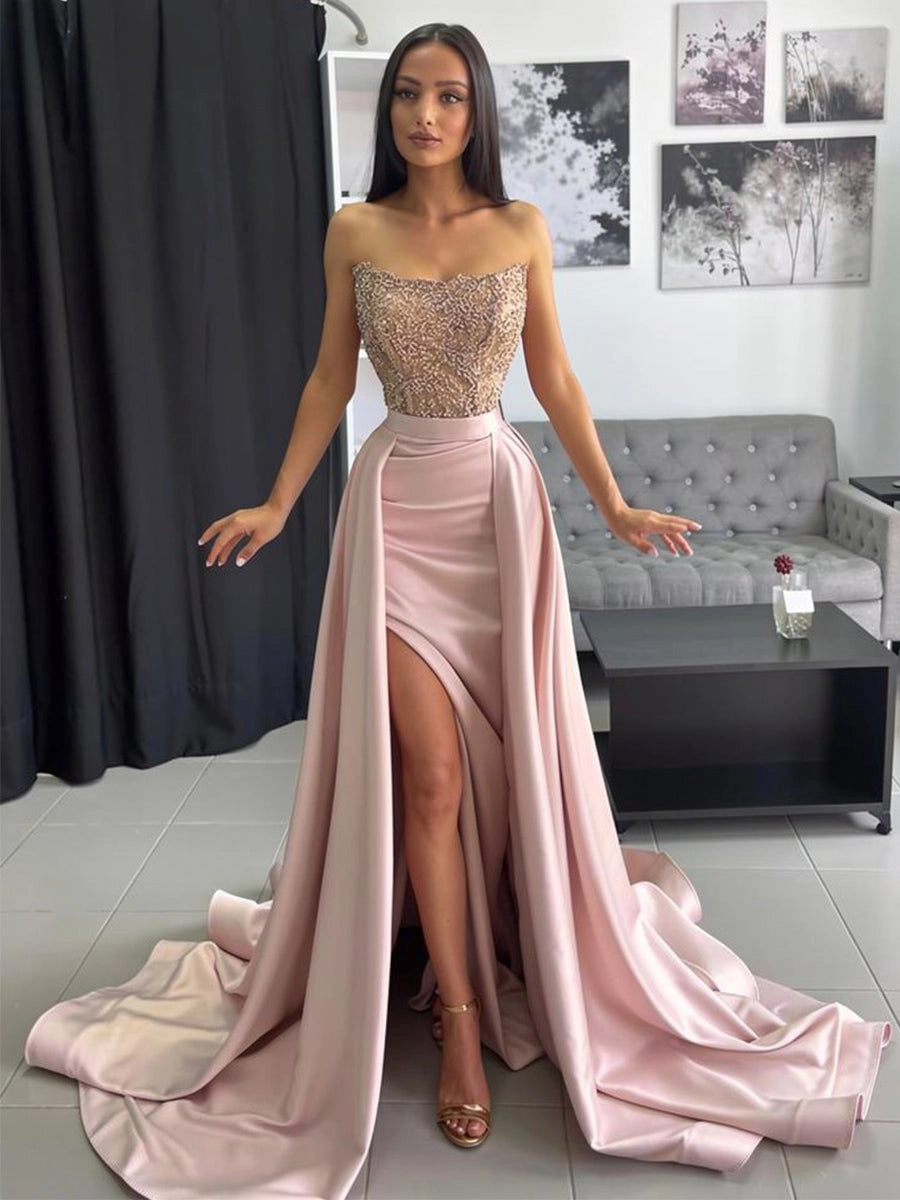 Blush pink satin prom dress with beaded sweetheart bodice, high slit and flowing overskirt front view
