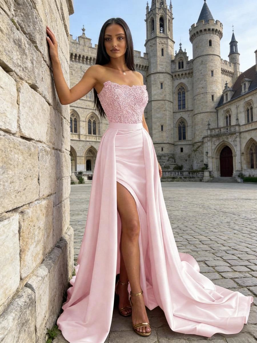 Blush pink satin prom dress with beaded sweetheart bodice, high slit and flowing overskirt front view

