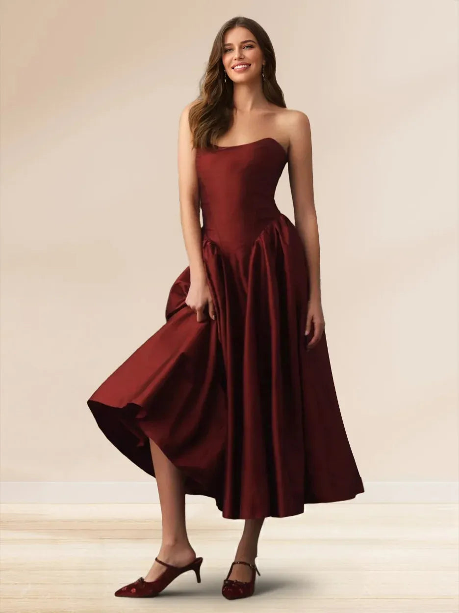 Front view of Loverlm burgundy strapless homecoming dress with asymmetric neckline, Basque waist and full midi A-line skirt