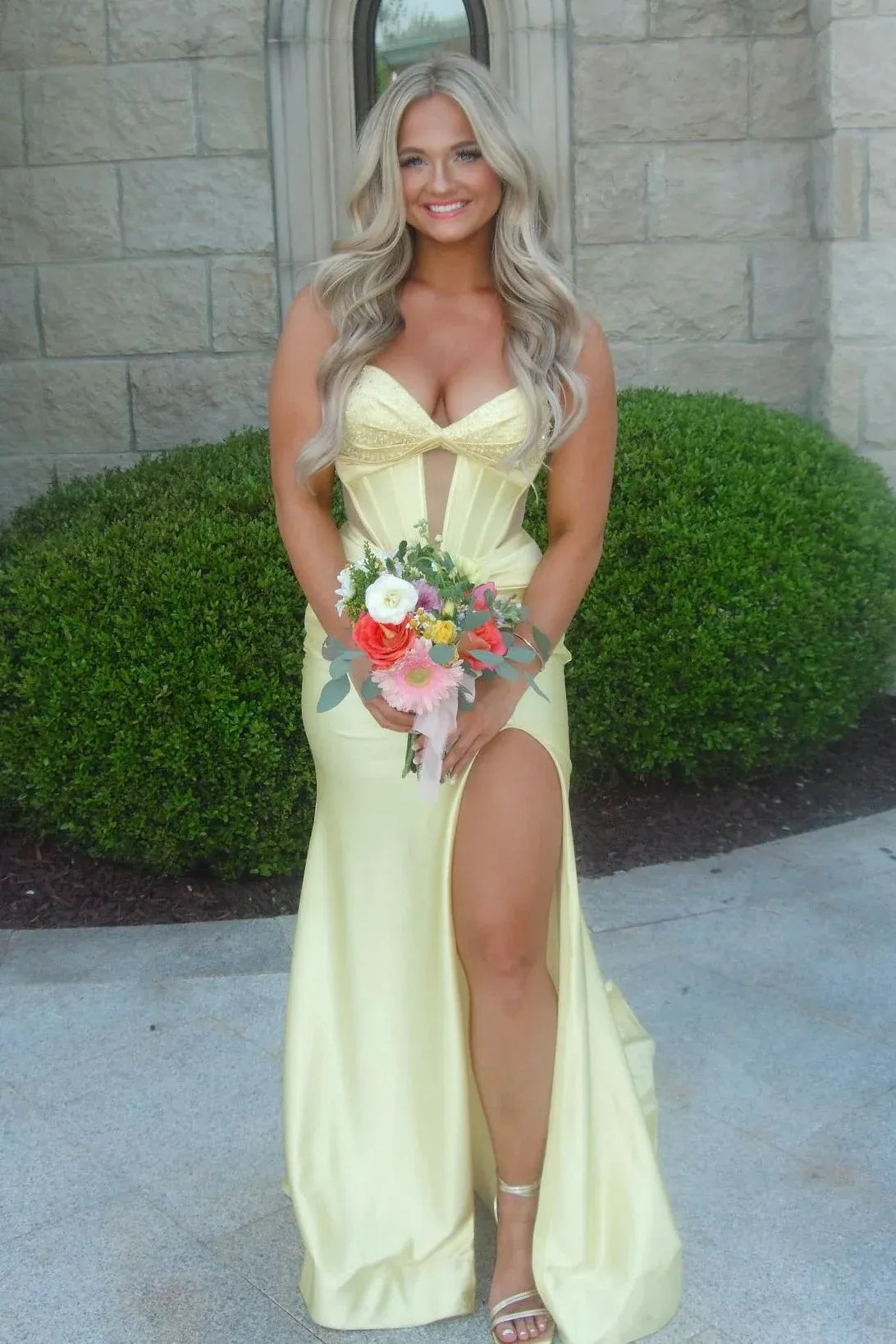 Loverlm butter yellow satin prom dress with a beaded sweetheart neckline, strapless sheer corset-style bodice and high-slit mermaid skirt.