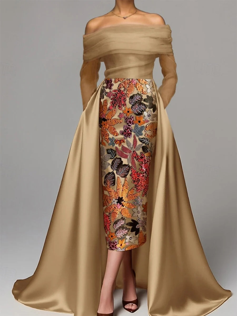 Champagne gold evening dress with colorful floral embroidery, off-the-shoulder sheer overlay, and flowing satin-look overskirt by Loverlm