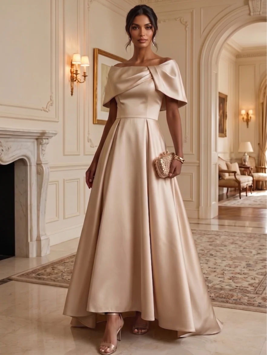 Champagne satin A-line mother of the bride dress with off shoulder cape sleeves, draped neckline, fitted waist and flowing high low hem by Loverlm