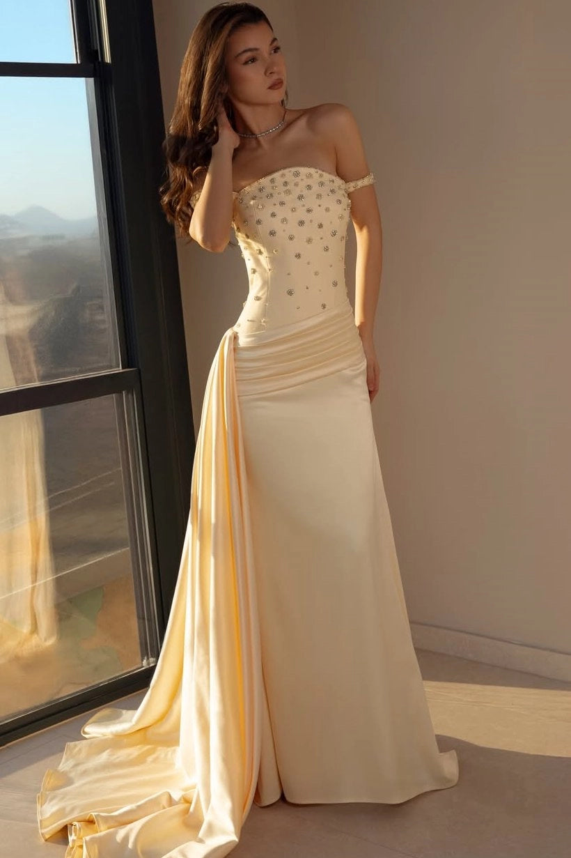 Front view of Loverlm champagne satin prom dress with sweetheart neckline, off-the-shoulder sleeves, crystal embellished bodice and draped train.