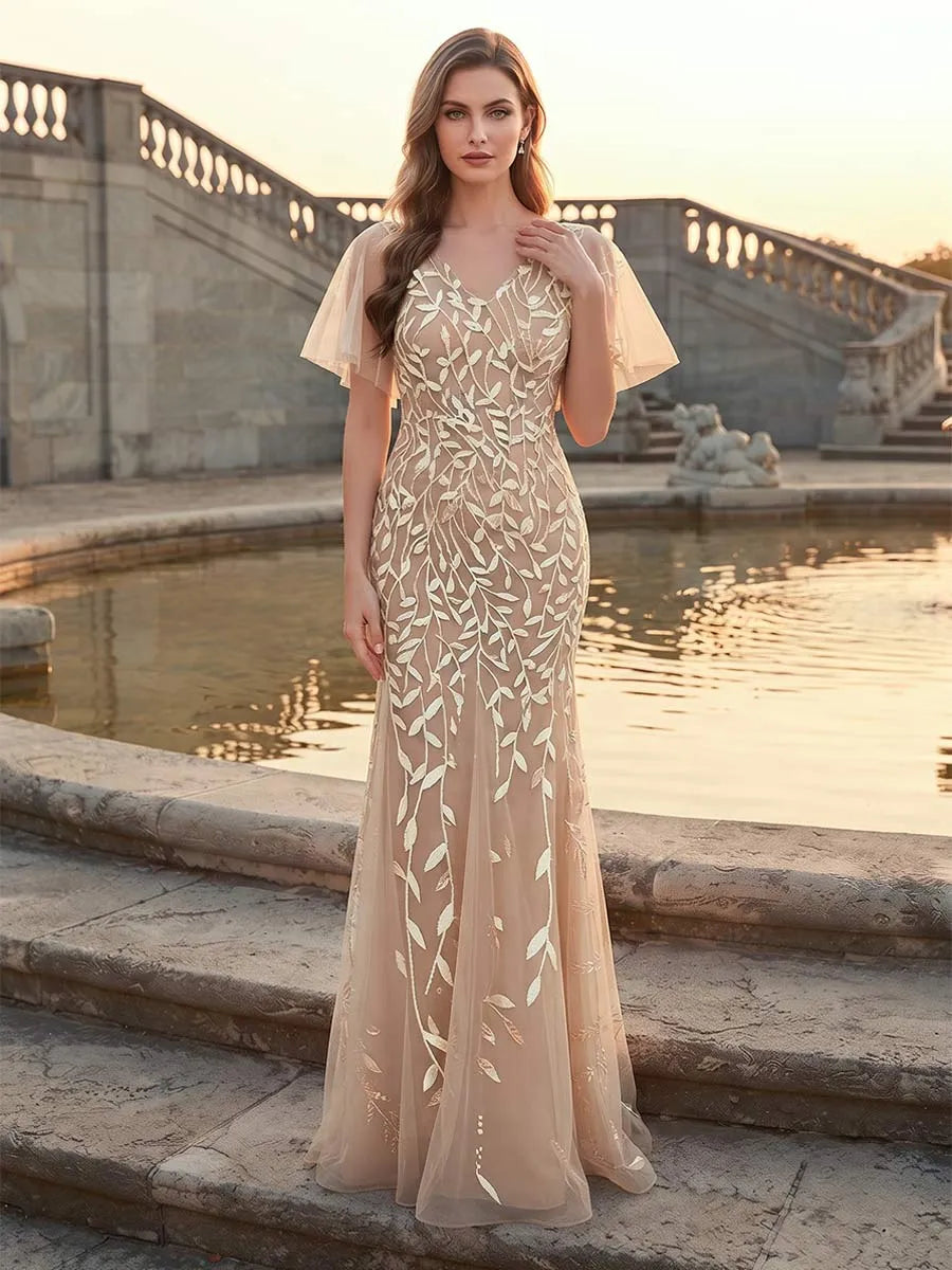 Front view of Loverlm champagne nude mother of the bride dress with V-neckline, sheer flutter sleeves and botanical embroidery