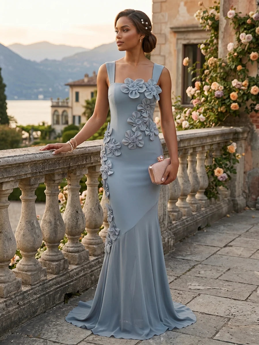 Dusty blue mermaid prom dress with square neckline, wide shoulder straps, cascading 3D floral appliques, fitted bodice and flowing floor-length skirt by Loverlm