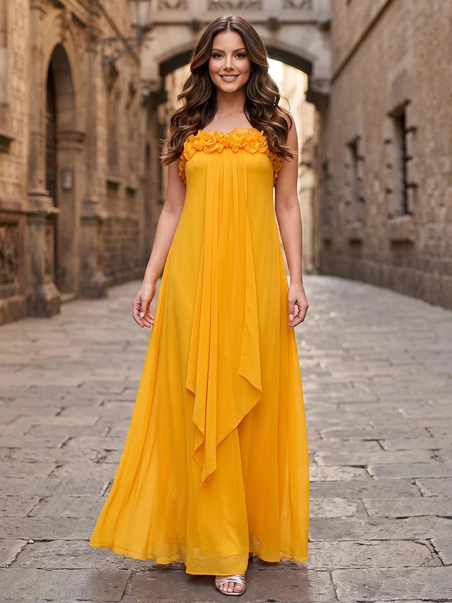 Golden yellow strapless chiffon wedding guest dress with floral ruffle neckline, cascading front drape and flowing floor-length A-line skirt by Loverlm