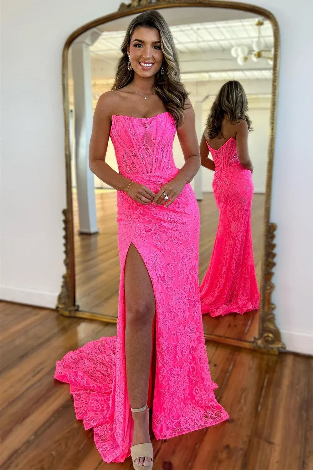 Front view of Loverlm hot pink lace mermaid prom dress with a strapless scoop neckline, corset bodice, ruched hips and a high slit.