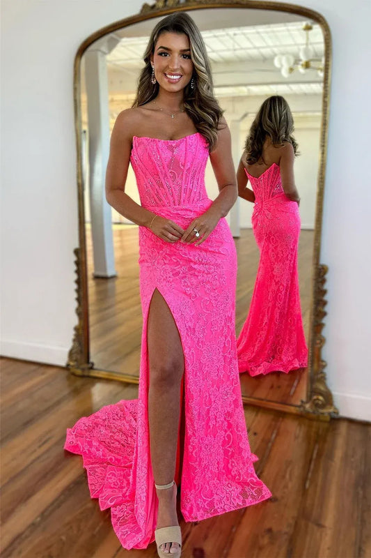 Front view of Loverlm hot pink lace mermaid prom dress with a strapless scoop neckline, corset bodice, ruched hips and a high slit.