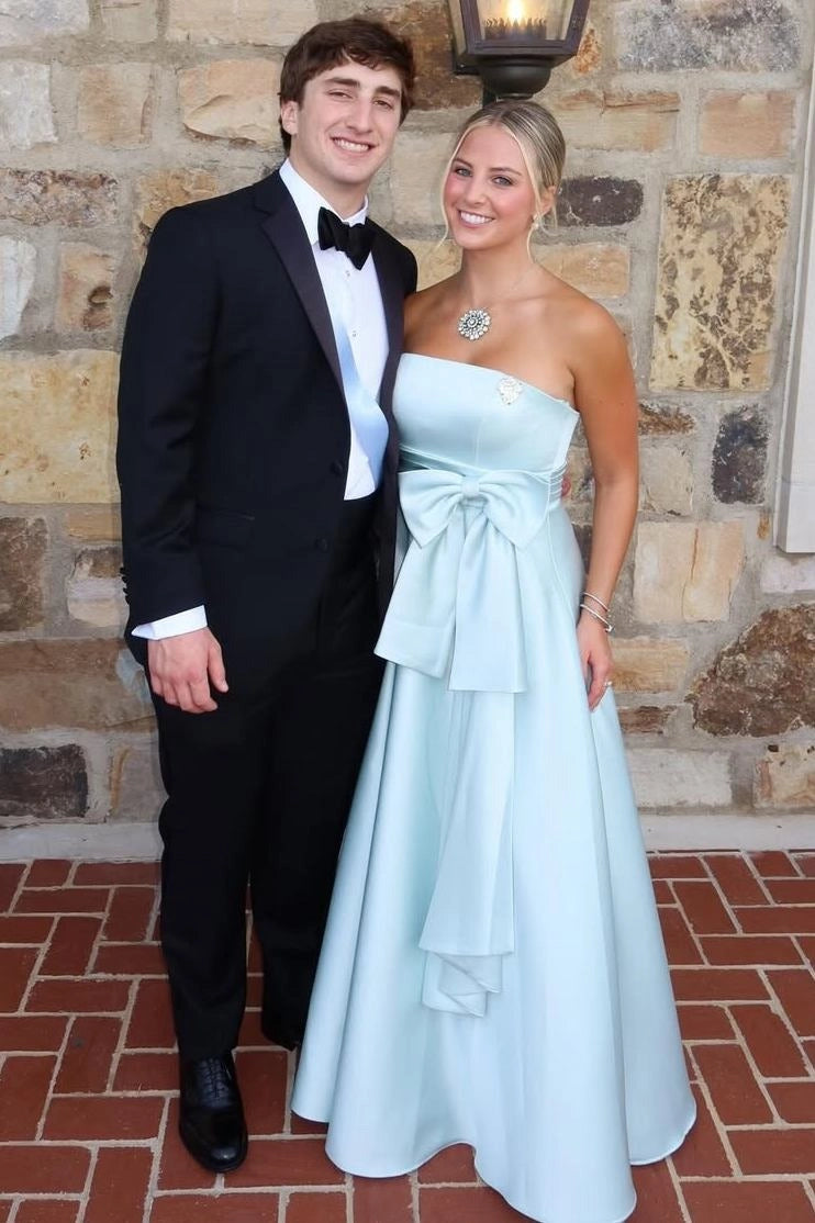 Close front view of Loverlm ice blue satin prom dress showing a straight strapless neckline, fitted bodice and oversized waist bow.
