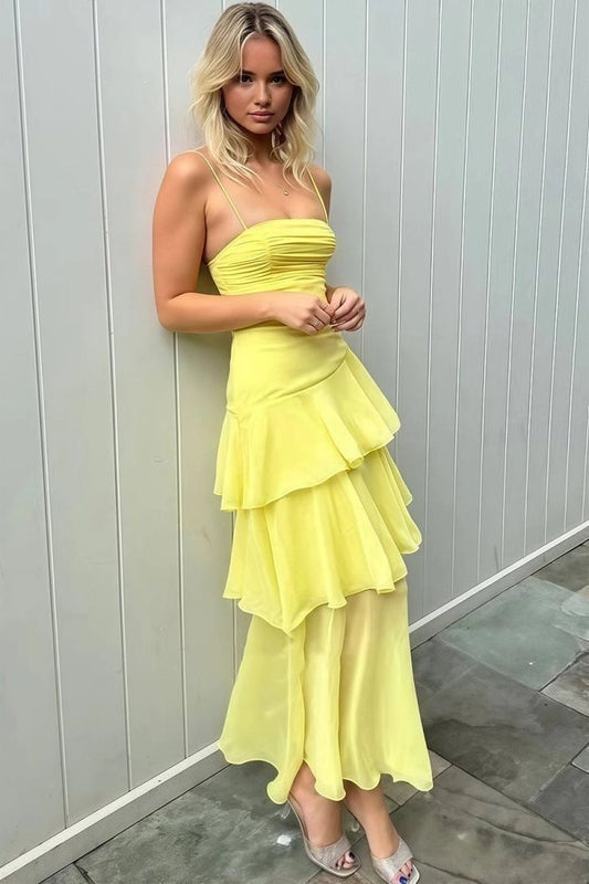 Front view of Loverlm lemon yellow dress with spaghetti straps, a ruched straight neckline and an ankle-length skirt with asymmetric ruffled tiers.