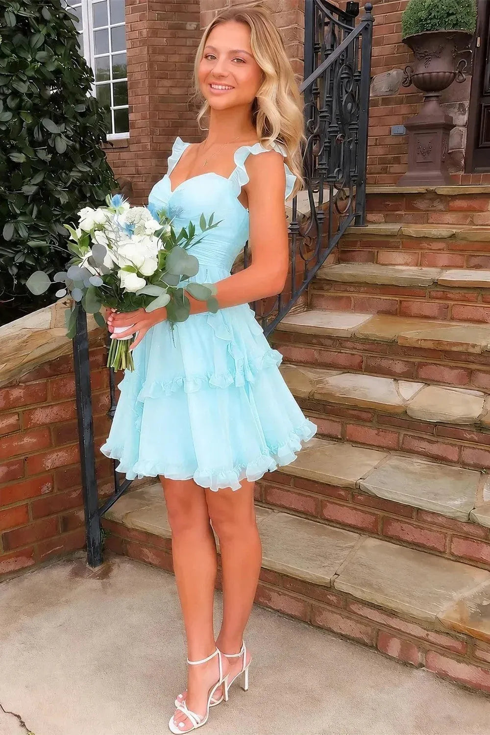 Front view of Loverlm light blue A-line mini homecoming dress with sweetheart neckline, ruffled shoulder straps and tiered ruffle skirt