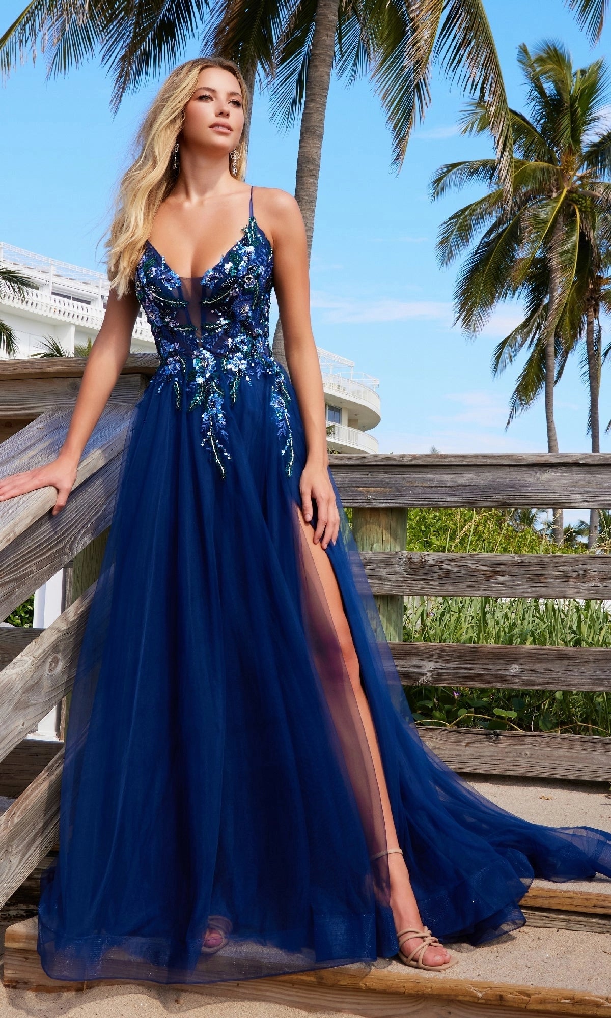 Navy blue A-line tulle prom dress with plunging V-neckline, floral sequin appliques, spaghetti straps, thigh-high slit and floor-length skirt by Loverlm
