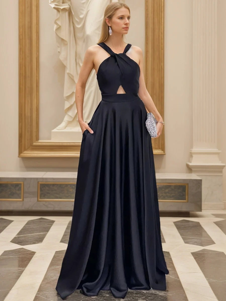 Navy blue satin A-line evening dress with twisted halter neckline, small front cutout, sleeveless bodice, side pockets and floor-length pleated skirt by Loverlm
