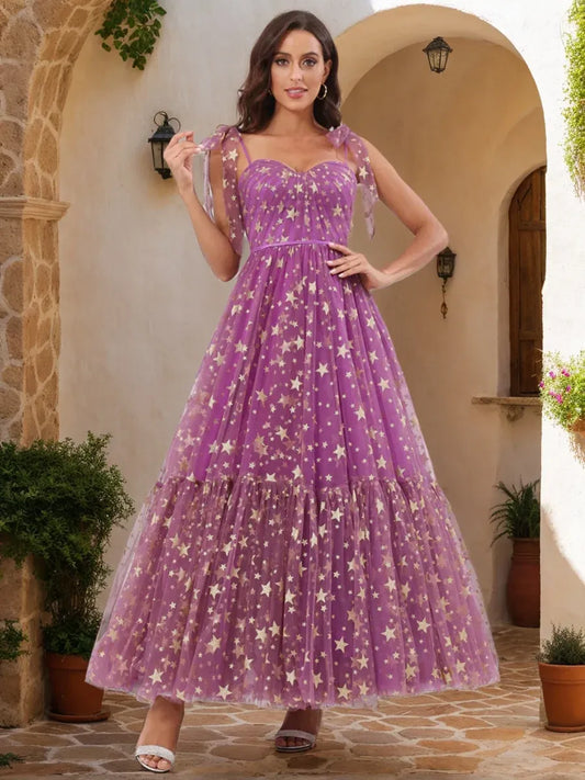 Front view of Loverlm orchid purple star print prom dress with sweetheart neckline, bow shoulder straps and tiered tulle A-line skirt