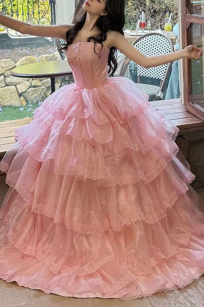 Front view of Loverlm pink prom ball gown with a straight strapless corset bodice and a full tiered organza skirt edged with floral lace.