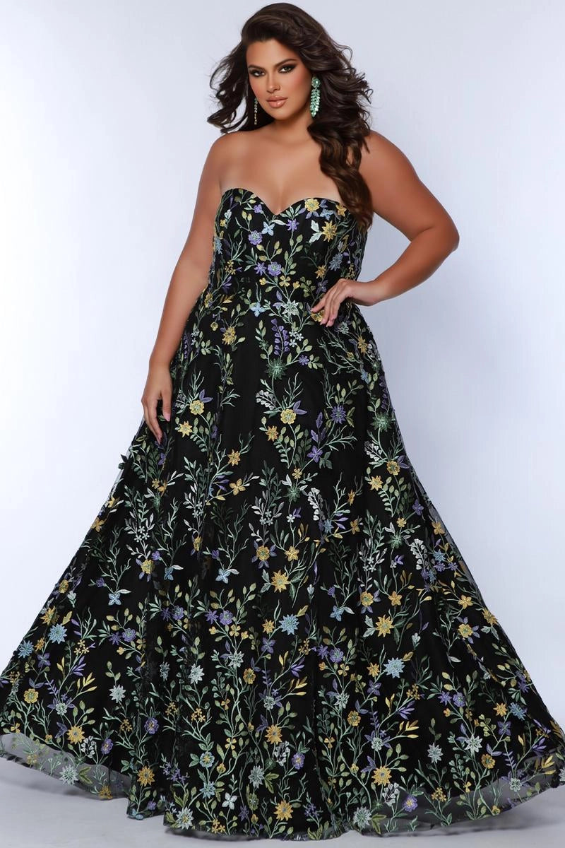 Plus size black floral embroidered tulle A-line prom dress with strapless sweetheart neckline, colorful botanical embroidery, fitted corset bodice, and full floor-length skirt
