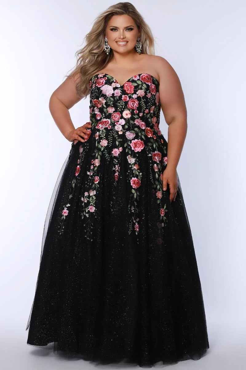 Plus size black floral embroidered tulle A-line prom dress with strapless sweetheart neckline, pink and red flower details, glitter finish, and full floor-length skirt