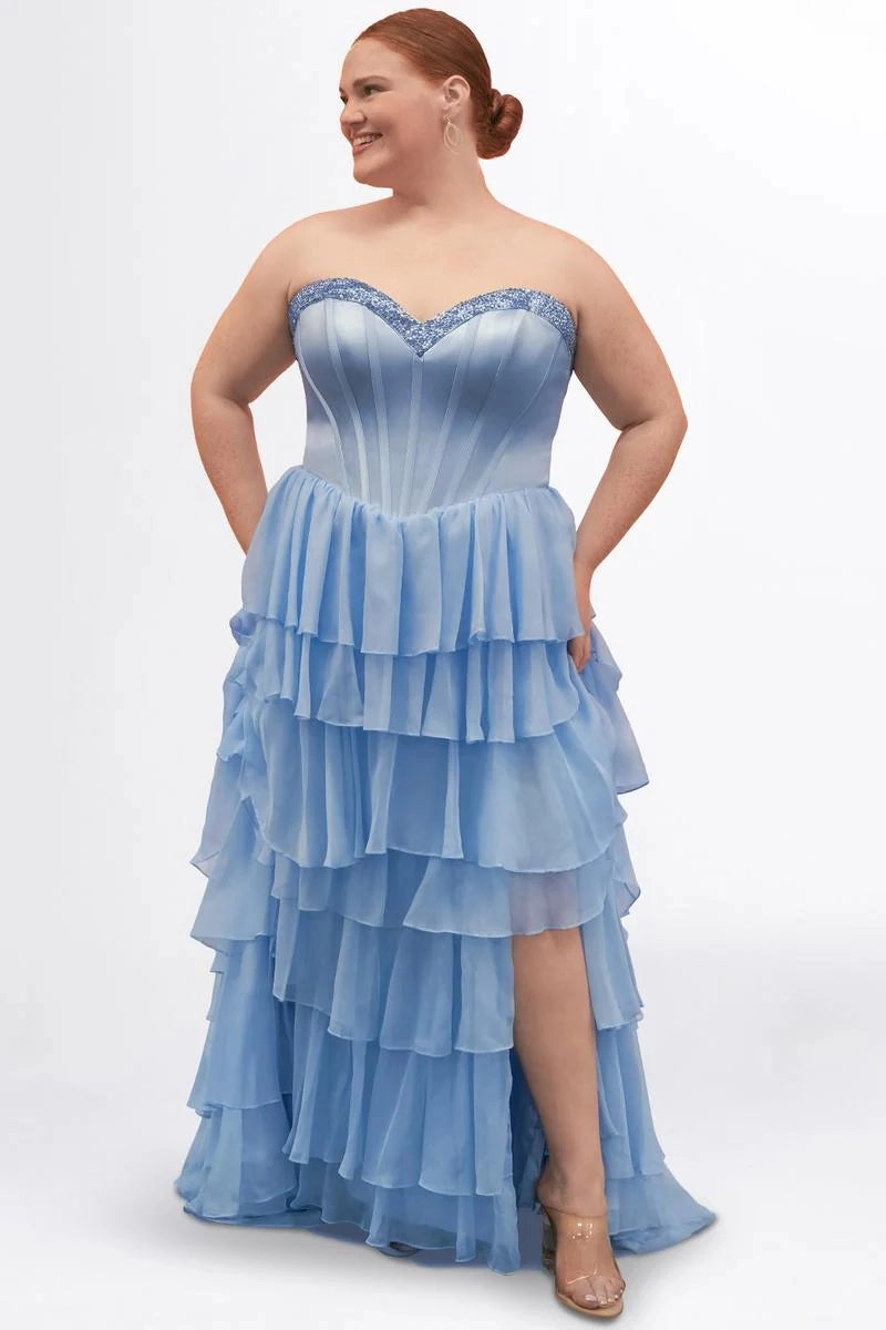 Plus size dusty blue chiffon A-line prom dress with sequin-trimmed sweetheart neckline, strapless corset bodice, tiered ruffle skirt, and front slit