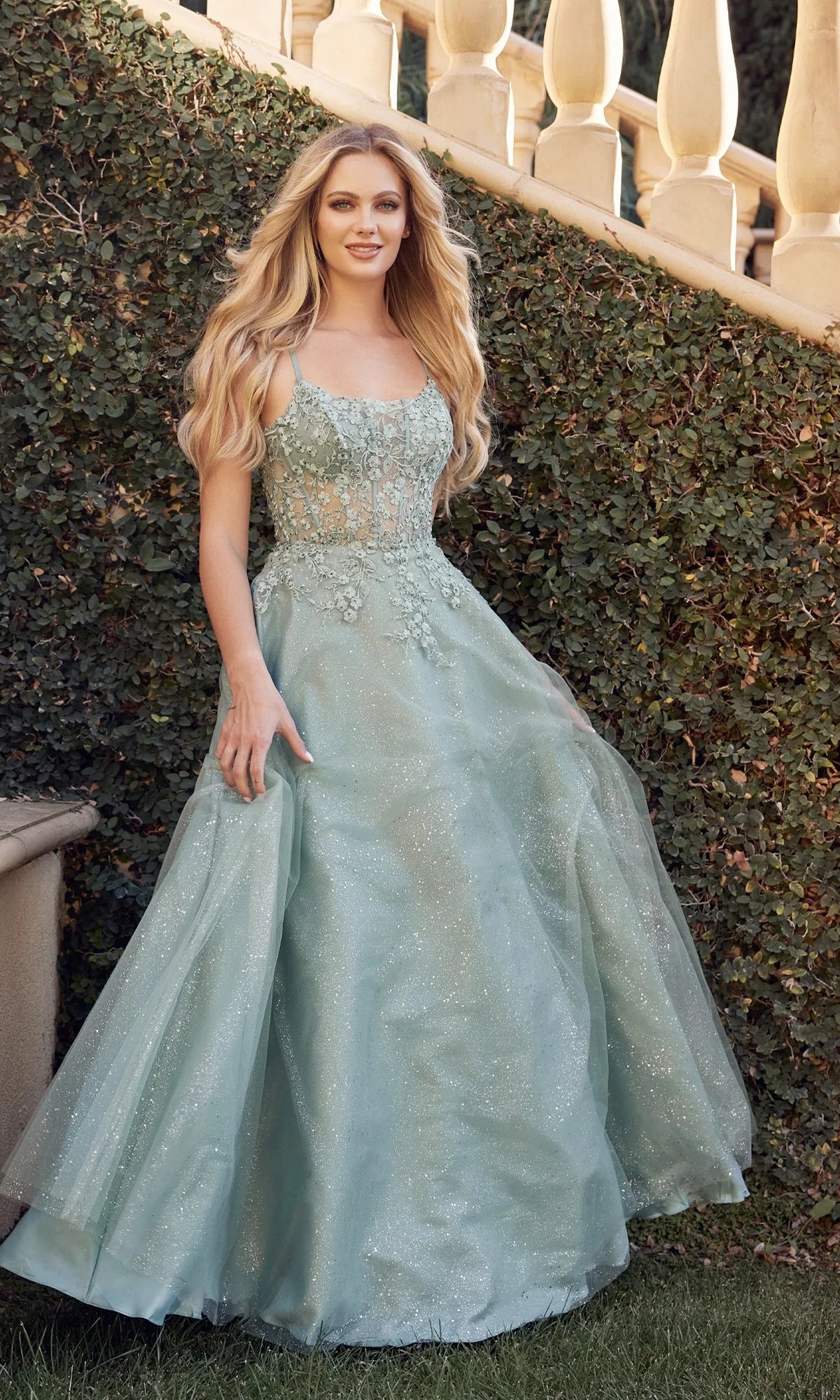 Sage green A-line prom dress with scoop neckline, spaghetti straps, floral lace illusion bodice and sparkling floor-length tulle skirt