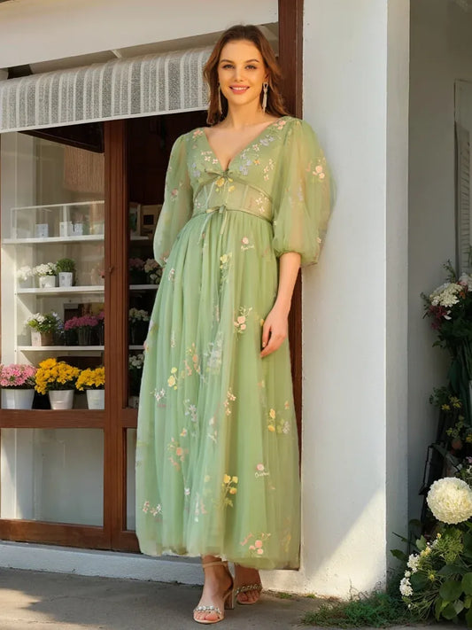 Front view of Loverlm sage green floral embroidered wedding guest dress with V-neckline, puff sleeves and flowing A-line skirt