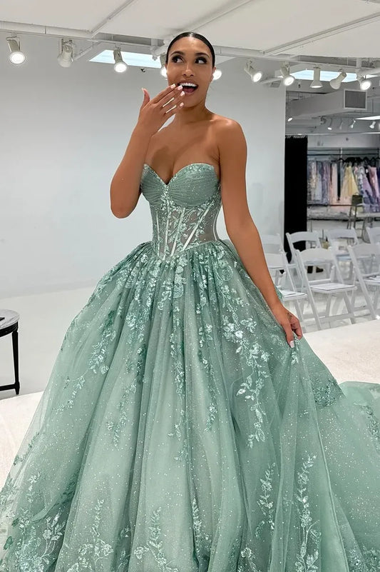 Loverlm sage green prom dress with a strapless sweetheart neckline, sheer corset bodice, floral appliques and a full glitter tulle A-line skirt.